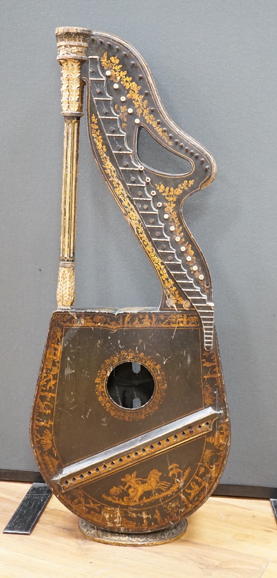 A Georgian parcel gilt and ebonised harp-lute by Edward Light, with fluted pillar, Royal coat of arms above patent number and ‘Light, Toley Place, London’, buttons to reverse with note letters, 88.5cm high CITES Submissi